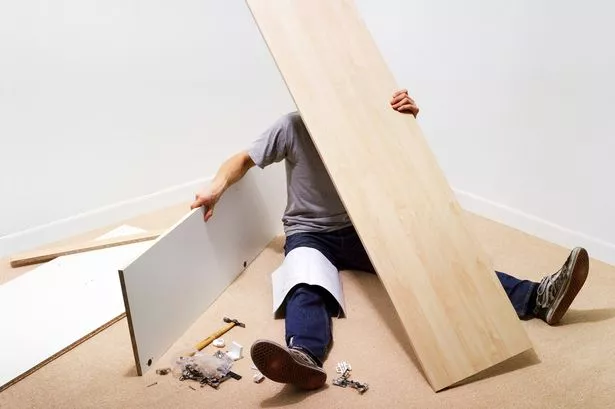 A Person struggling with furniture assembly