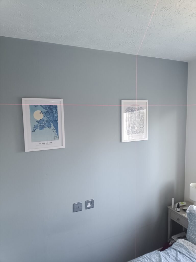 Pictures hung level on a wall using a laser line