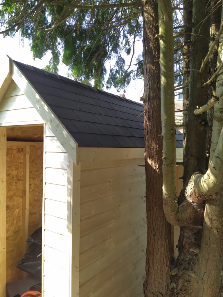 Finished timber garden building with shingle roof, built by TradesPro