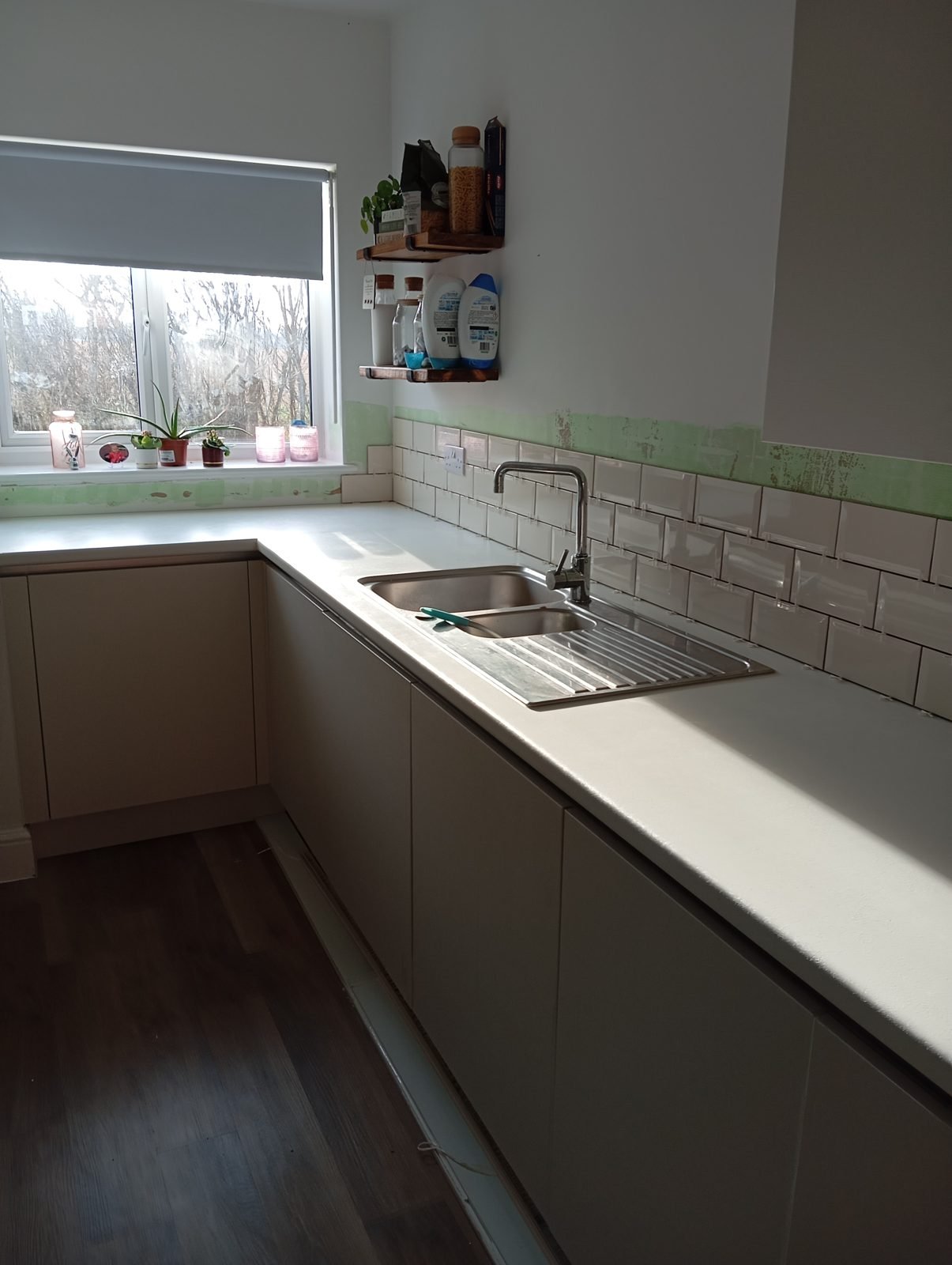 Metro tiles going on behind the sink with spacers in place